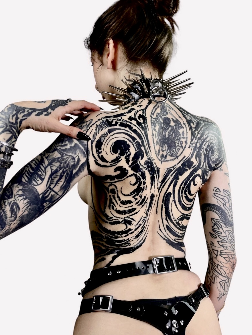 Healed blackwork back piece with swirling ornamental forms