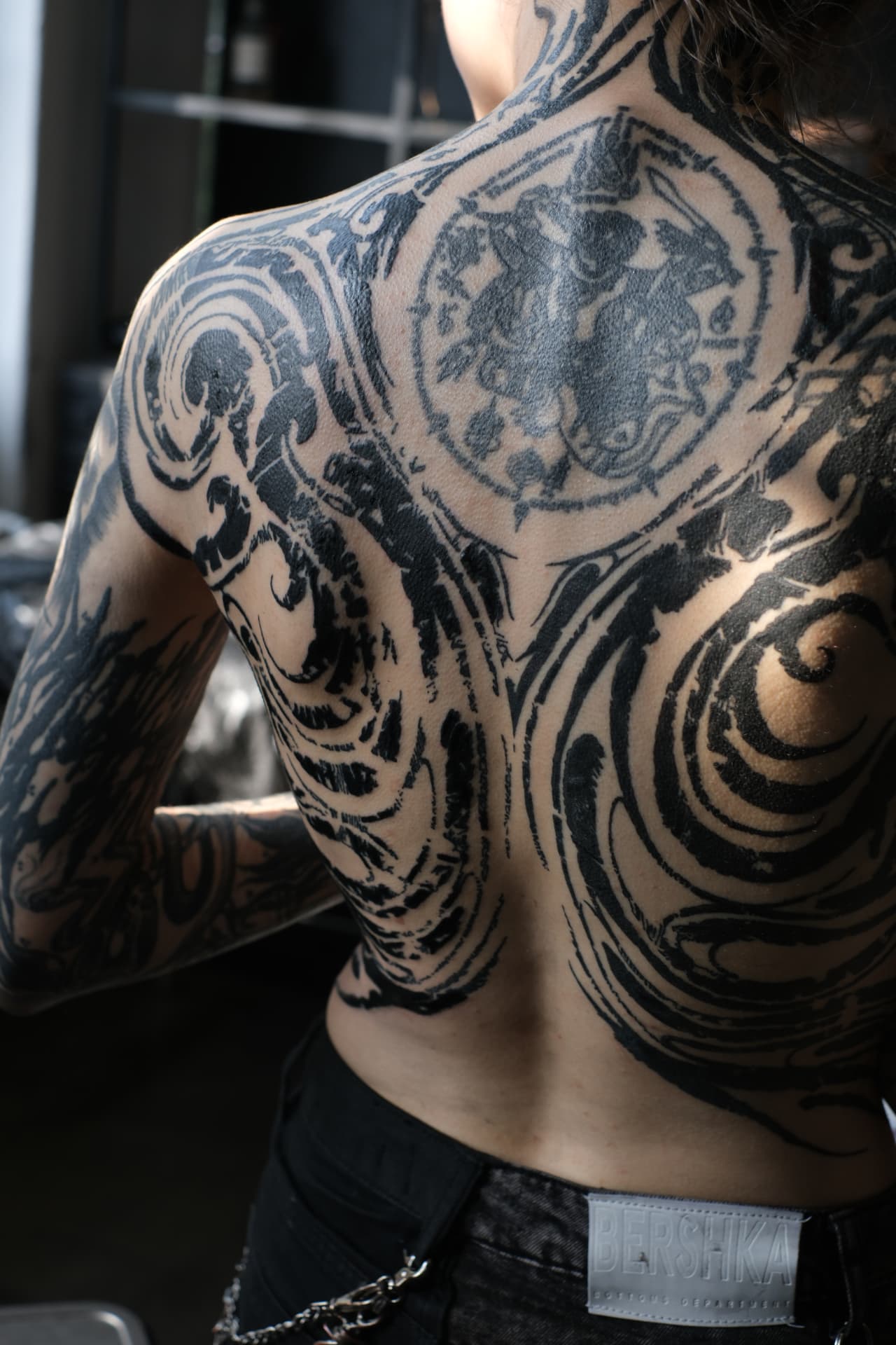 Close-up of healed ornamental blackwork across the shoulder and back